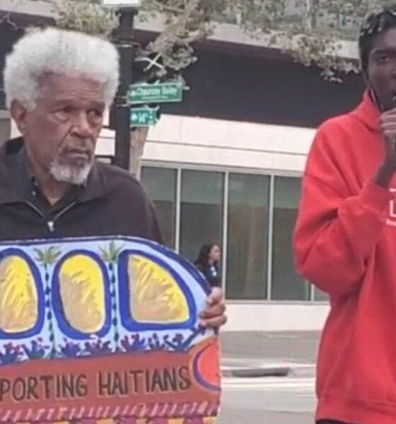 Activists Gerald Smith and Romaine Charite at 14th and Broadway in downtown Oakland near City Hall protest in support of Haitian immigrant rights. Photo by Carla Thomas