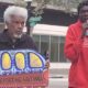 Activists Gerald Smith and Romaine Charite at 14th and Broadway in downtown Oakland near City Hall protest in support of Haitian immigrant rights. Photo by Carla Thomas