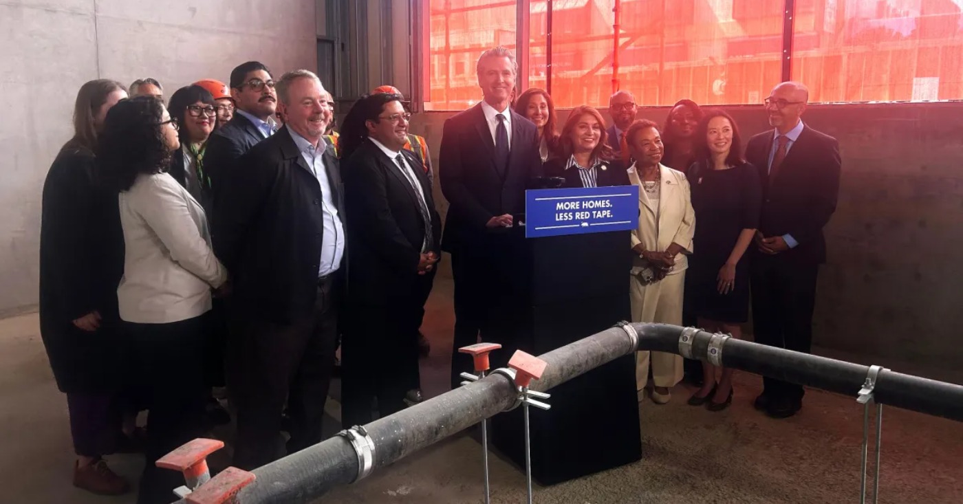 California Governor Gavin Newsom stands with public officials after signing Assembly Bill 179 in Oakland, Calif., on July 13 2026. Assembly Bill 179 modernizes how California finances and delivers affordable housing. (Lloyd B Davis/Bay City News)