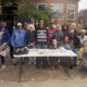 Zakiya Jendayi, center, surrounded by supporters at the weekly gathering at her house to halt her eviction. Photo by Tanya Dennis.