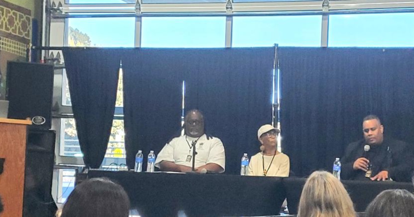 Quixote Atkins of VillageGIVE moderates a panel discussion at the Coliseum 60 celebration at Youth UpRising featuring Keith Brown, a member of IATSE Local 107; author, historian and former Black Panther Party member Tareka Lewis; and African American Sports and Entertainment Group President Ray Bobbitt.