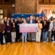Flanked by students, holding the check to the college are (l.-r.) U.S. Rep Lateefah Simon, Renee Jadushlever and Dan Sachs of MCNUO and Oakland Mayor Barbara Lee. Courtesy photo.